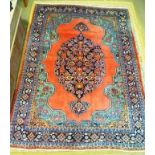 A PERSIAN DESIGN CARPET having pink ground with central device in blues, deeply bordered with