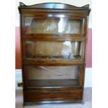 AN EDWARDIAN MAHOGANY GLOBE WERNICKE DESIGN STACKING BOOKCASE, fitted gallery back over three glazed