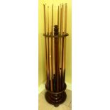 A MAHOGANY FLOOR STANDING SNOOKER CUE STAND with turned decoration, rotating on a circular