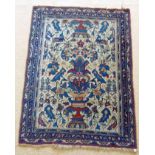 A PERSIAN RUG with cream ground stylised vase and floral decoration, in reds, blues and pale