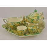 A CROWN DUCAL EARTHENWARE MORNING TEASET decorated with yellow flowers and green leaves, pattern