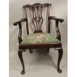 A CHIPPENDALE DESIGN PIERCED SPLAT BACK MAHOGANY OPEN ARM CHAIR, with floral woolwork drop-in