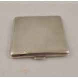 A SQUARE SILVER LADY'S POWDER COMPACT having engine turned exterior, possibly London 1922, 63mm