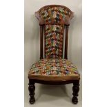 A VICTORIAN MAHOGANY FRAMED PRIE-DIEU CHAIR having column flanked high back, upholstered seat and