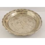 A FOREIGN SILVER COLOURED METAL BOWL/PLATTER having wavy tooled and worked rim, 37cm diameter, 1156g