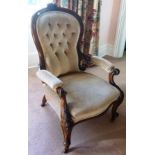 A VICTORIAN STAINED BEECH FRAMED OPEN ARM BUTTON BACK SALON CHAIR, carved crest decoration, scroll