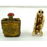 A GILT METAL SNUFF BOTTLE decorated with mystic clouds and a CARVED BONE SKELETON ORINOKO