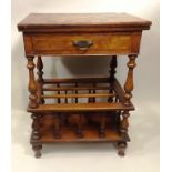 A VICTORIAN WALNUT CANTERBURY GAMES TABLE having inlaid and chequer board foldover top with drawer