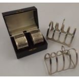 ROLASON BROTHERS A PAIR OF SILVER CHASED NAPKIN RINGS, Birmingham 1908, cased, and two silver