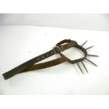A PROBABLY 19TH CENTURY SPIKED LEATHER DOG COLLAR with restraining strap, each spike 7cm long