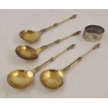 A SET OF FOUR FOREIGN SILVER COLOURED METAL APOSTLE TERMINAL SPOONS each portraying the same