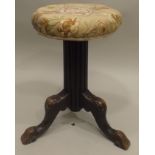 A PART VICTORIAN STOOL, having upholstered circular seat on ebonised reeded column with tripod