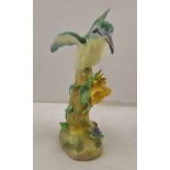 A CROWN STAFFORDSHIRE MODEL OF A 'BEE EATER' on a flowering tree stump decorated in polychrome,