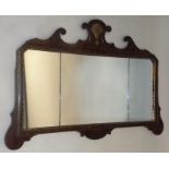 A 1920's WALL MIRROR having shaped surround with triple segmented plate