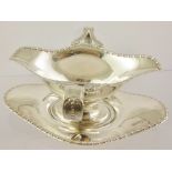 BARKER BROS A DOUBLE LIPPED SILVER SAUCE BOAT on a stand of shaped oval form with egg and dart