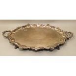 A LATE GEORGIAN DESIGN SILVER PLATED A1, TWO-HANDLED TEA TRAY, scallop decorated rim, with ornate