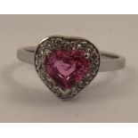 A RHODIUM FINISHED WHITE GOLD COLOURED METAL LOVER'S RING, the head set with a heart shaped cut pink