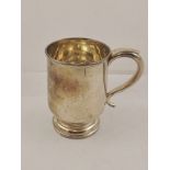 WALKER & HALL A SILVER PINT MUG having moulded wire rim, scroll handle and plain body, Sheffield