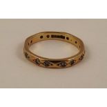 A 9ct GOLD DIAMOND SET FULL ETERNITY RING having twelve pairs of 8/8 cuts in a facetted setting,