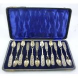 A CASED SET OF TWELVE PIERCED SILVER SPOONS, 165g