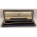 A GRADUATED ROW OF CULTURED PEARLS with 9ct gold clasp, 45cm long