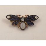 A SILVER GILT MOUNTED INSECT/BUTTERFLY BROOCH set with sapphires and moonstones