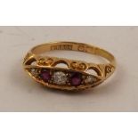 AN 18CT GOLD LADY'S RING set with three diamonds and two rubies