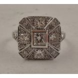 A RHODIUM FINISHED 18CT WHITE GOLD CLUSTER RING, having tablet shape top set with princess and