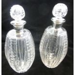 GOLDSMITHS & SILVERSMITHS CO. A PAIR OF SILVER MOUNTED CUT GLASS WINE DECANTERS each having blown