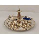 A THREE PIECE STERLING SILVER CONDIMENT SET and a bead rimmed waiter 16cm diameter, total weight