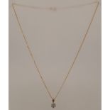 A 9CT GOLD MOUNTED PENDANT set with seven brilliants, on a hammered curb link 9ct gold chain