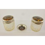 H** MATHEWS A PAIR OF SILVER AND TORTOISESHELL CAPPED LEAD CRYSTAL DRESSING TABLE JARS each with cut