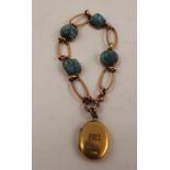 A GOLD COLOURED METAL BRACELET set four cabochon turquoise matrix, with yellow metal locket