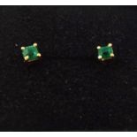 A PAIR OF POSSIBLE EMERALD SET STUD EARRINGS, in gold coloured metal setting