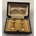 A PAIR OF GOLD COLOURED METAL PEARL DROP EARRINGS each with two pearls and screw fittings stamped