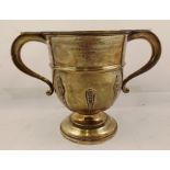 BARKER BROS. SILVER LTD. A TWO-HANDLED TROPHY CUP, banded and decorated with foliate strappings,