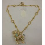 A CHANEL DIAMANTE AND COLOURED GLASS SET PENDANT fashioned as a poodle, on fancy chain