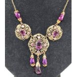 A 1930's CZECH GILT AND AMETHYST GLASS SET NECKLACE with allover filigree work and matching EARRINGS