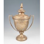 A silver twin handled trophy, the circular body of tapered form raised on circular stepped foot,