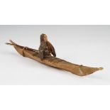 An early 20th Century Inuit kayak toy model, the kayak of wood and animal hide construction with