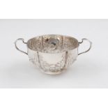 A Victorian silver two handled bowl, of fluted design with repousse floral swag and bow design, with