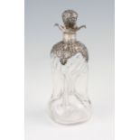A Victorian silver mounted decanter with scroll and foliage design silver collar and stopper with