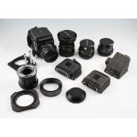 A Mamiya RB67 camera outfit comprising of body, four lenses, four Polaroid backs, metering prism,