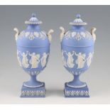 A pair of early 19th Century Wedgwood jasper ware lidded pedestal vases with ovoid bodies having