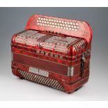 A Hohner Shand Morino 46 button key accordion finished with red pearl design with chromed fittings
