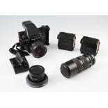 A Mamiya 645 camera body, together with three lenses 80mm F2.8, 35mm F3.5 and 105mm to 210mm zoom,