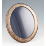 A silver oval photo frame, of plain design with velvet reverse, hallmarked Sheffield 1985, height