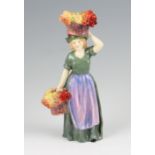 A Royal Doulton figure ‘Covent Garden’ HN 1339, dressed in green and mauve with two baskets of