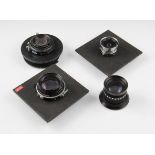 Four various large format lenses including Schneider and Rodenstock, two lenses on lens boards.