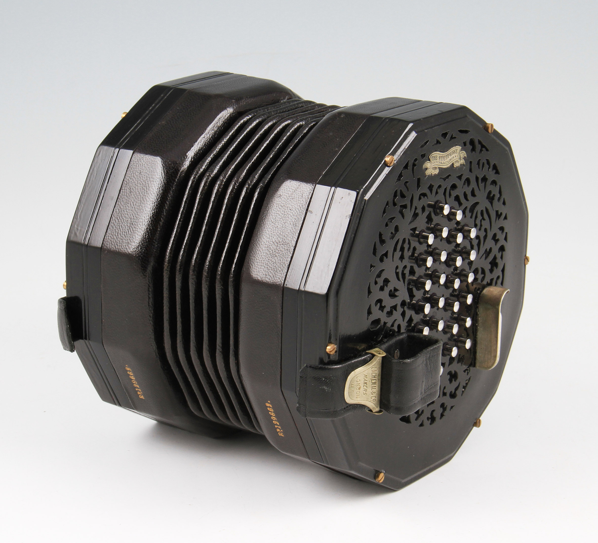 A Lachenal & Co 'The Edeophone' concertina, with black ebonized body with fretwork end sections with